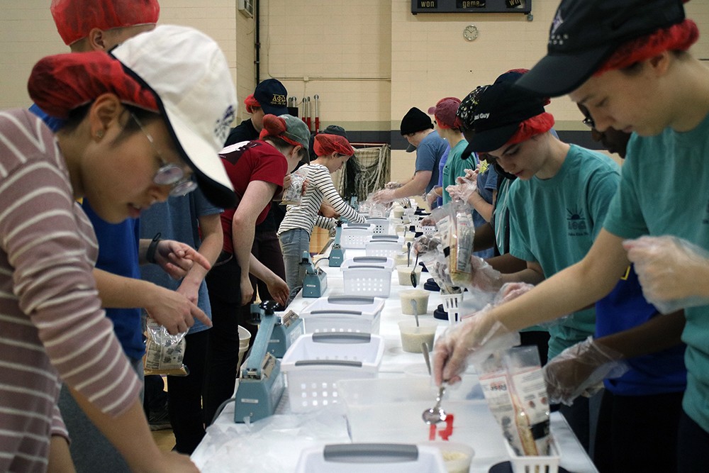 Furman students and volunteers pack meals for the hungry