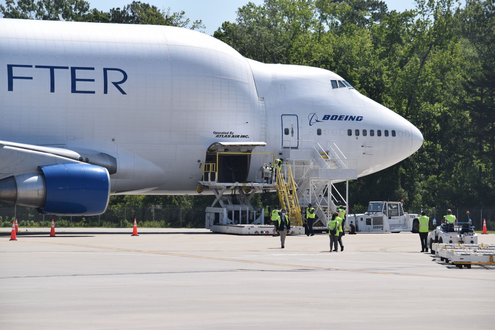 Boeing employees and contractors unload pallets of personal protective equipment from a Boeing Dreamlifter. (Photo/Patrick Hoff)