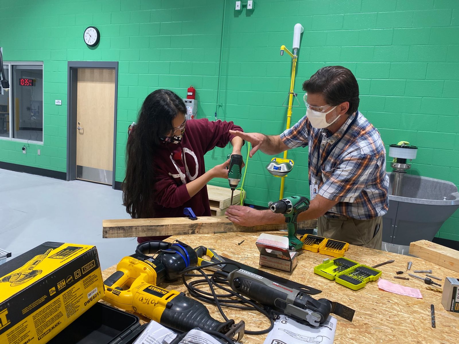 Cooper River Center for Advanced Studies teacher Gary Careaga offers a hands-on lesson to a mechatronics student. (Photo/Charleston County School District)