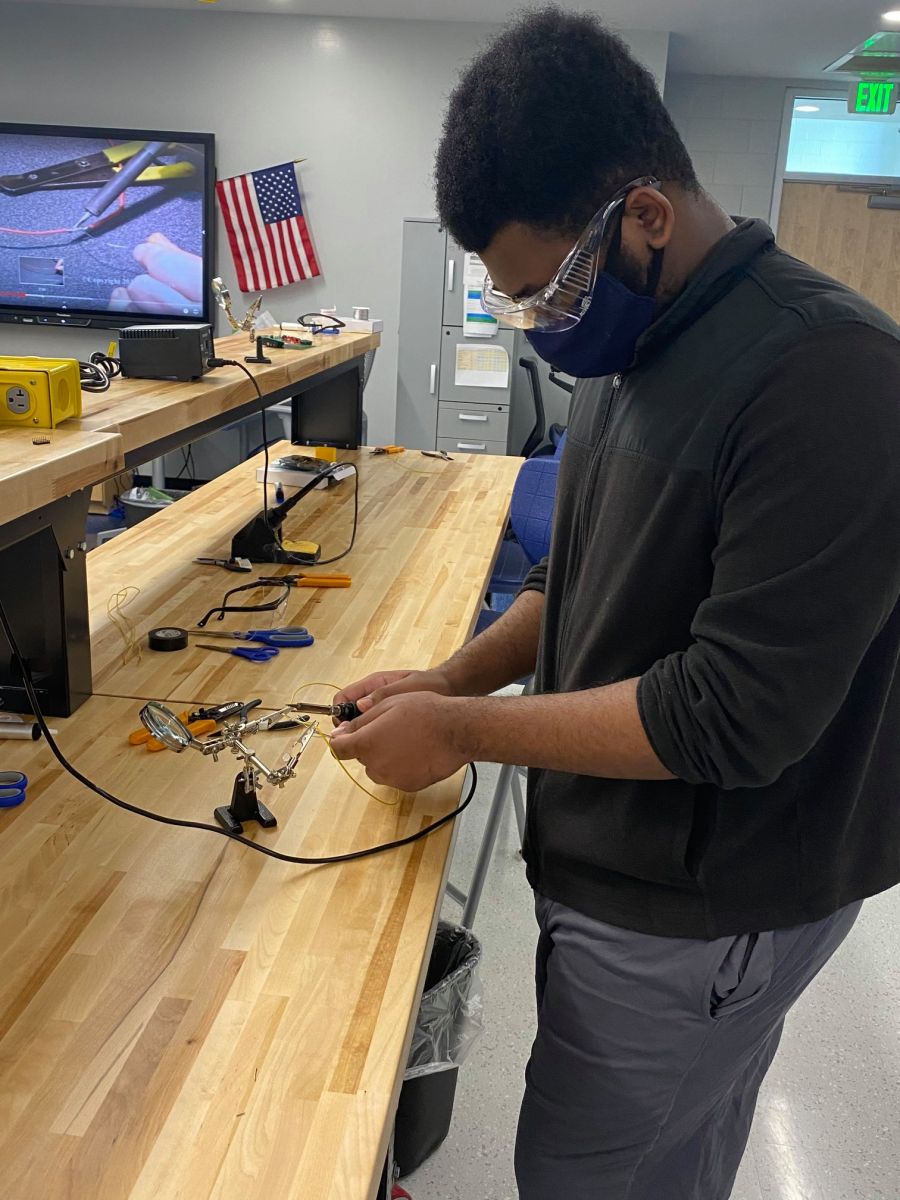 A student practices soldering electronic components during a Project Lead The Way digital electronics class. (Photo/Charleston County School District)
