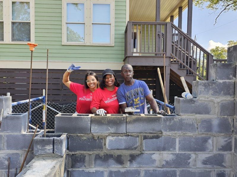 Wells Fargo employees, above and below, volunteer at the Habitat for Humanity build in North Charleston. (Photo/Provided)