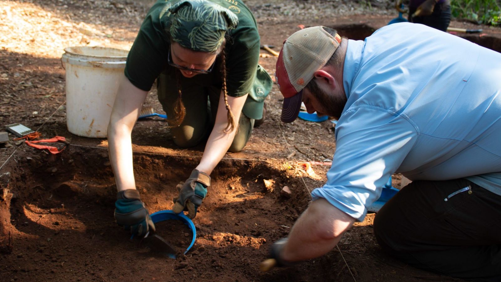 David Markus (right) joins an undergraduate student to carefully remove soil from the dig site. (Photo/Provided)