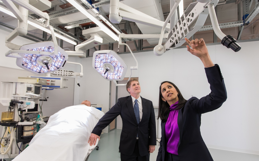 Dr. Scott Reeves (left) and Anjali Joseph examine the operating room prototype. Equipment was provided by medical device companies that have partnered with the project. (Photo/Medical University of South Carolina)