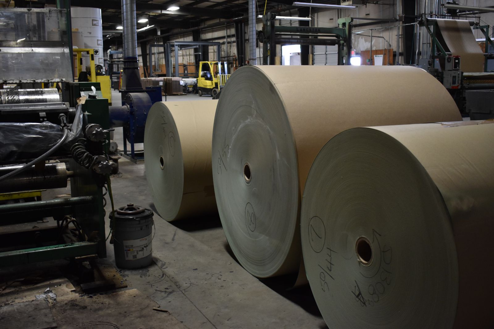 Rolls of paper to be cut and printed for use between pallets at Paper Cutters' facility. (Photo/Molly Hulsey)