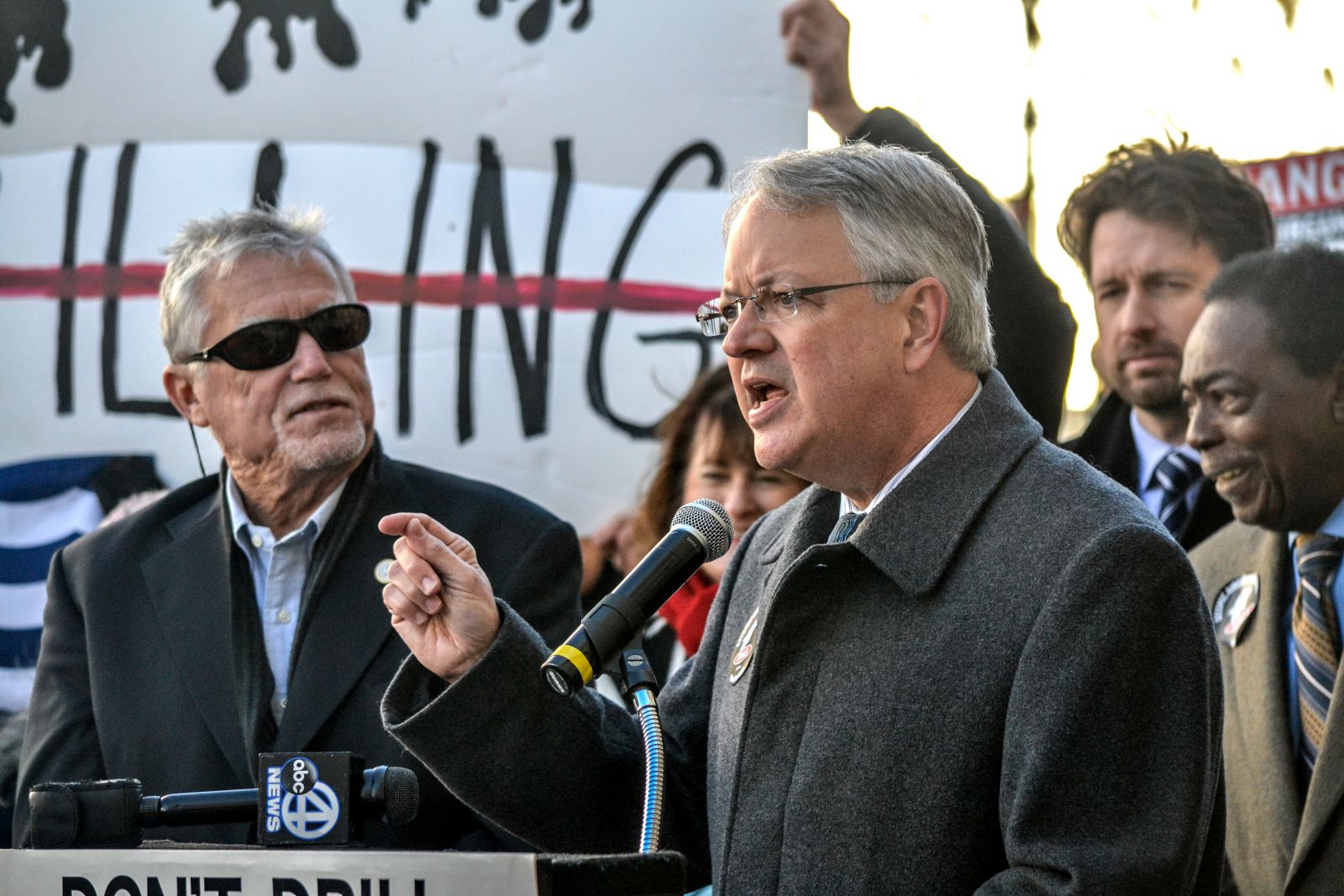 Charleston Mayor John Tecklenburg said offshore drilling activities have no place in the Lowcountry. Residents held up anti-drilling signs while he spoke during a news conference Tuesday on Broad Street. (Photo/Liz Segrist)