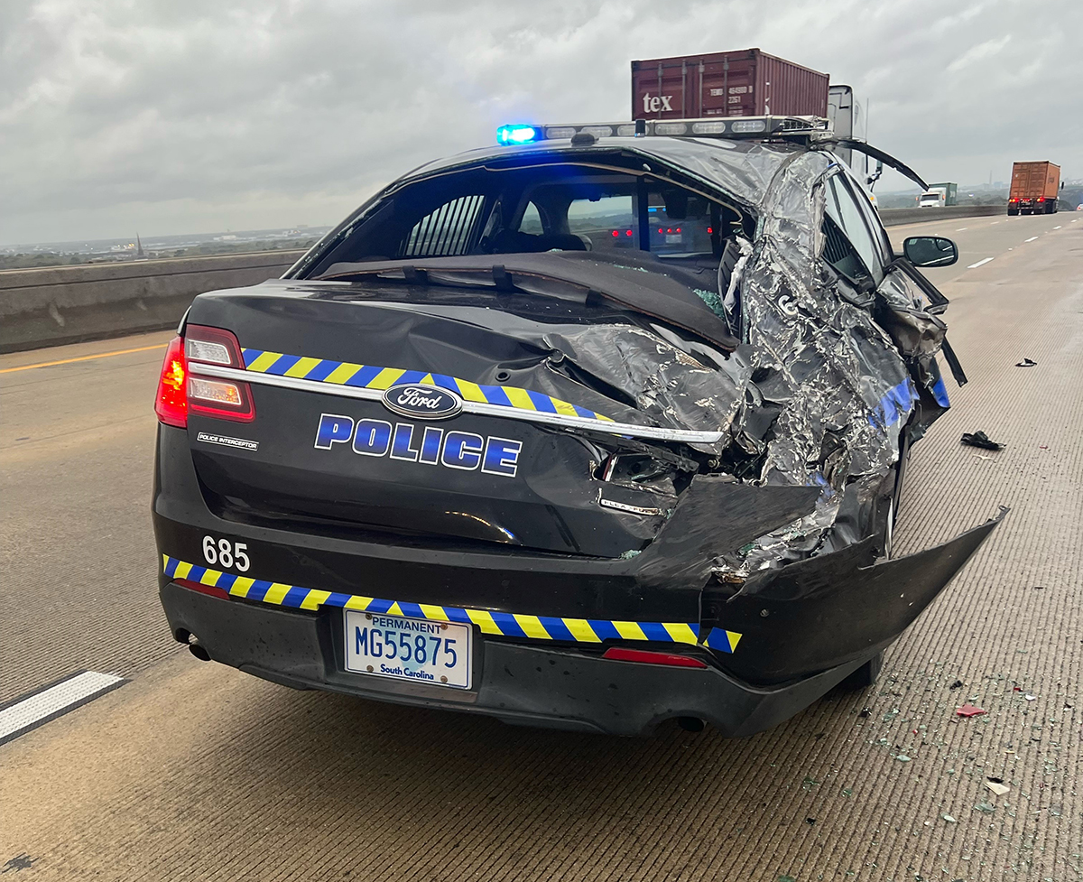A Charleston Police Department cruiser was damaged on the Wando Bridge after wind blew a container off of the truck, into the car and over the bridge into the water. (Photo/Charleston Police Department)