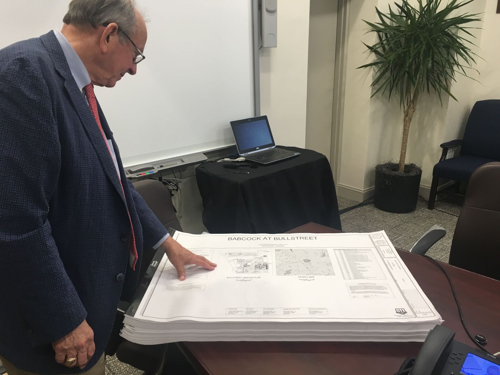 Columbia City Councilman Howard Duvall, chair of the Bull Street commission, examines plans for luxury apartments at the Babcock building in the BullStreet District. (Photo/Ren??e Sexton)