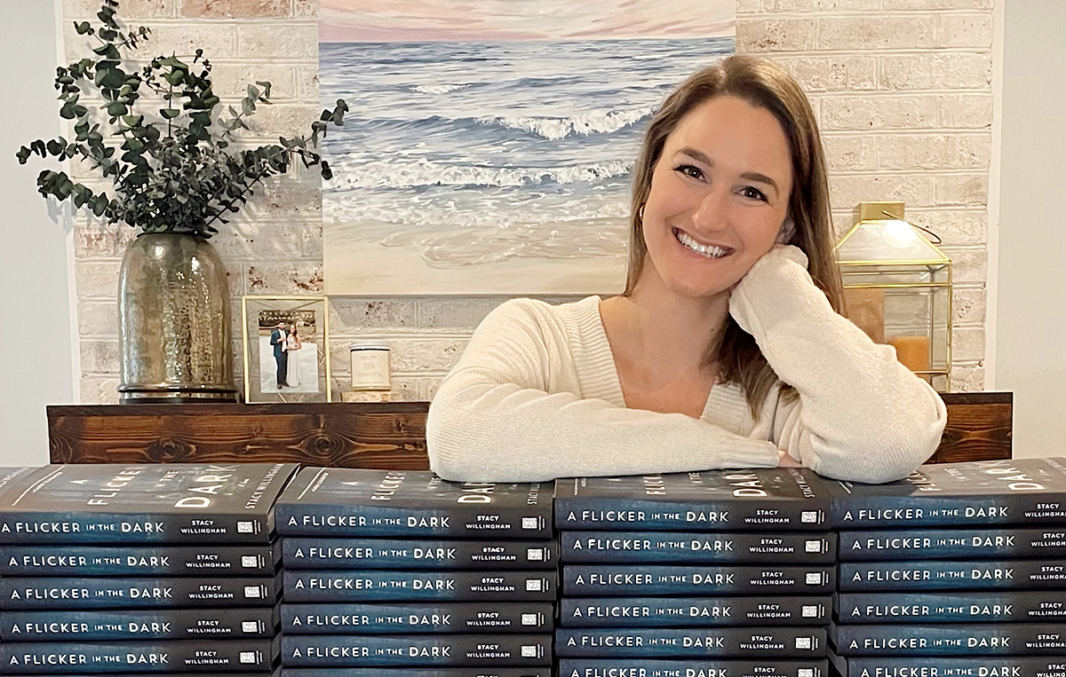 Stacy Willingham stands with a stack of her debut novel, A Flicker in the Dark, which has just been picked up by HBO. (Photo/Provided)