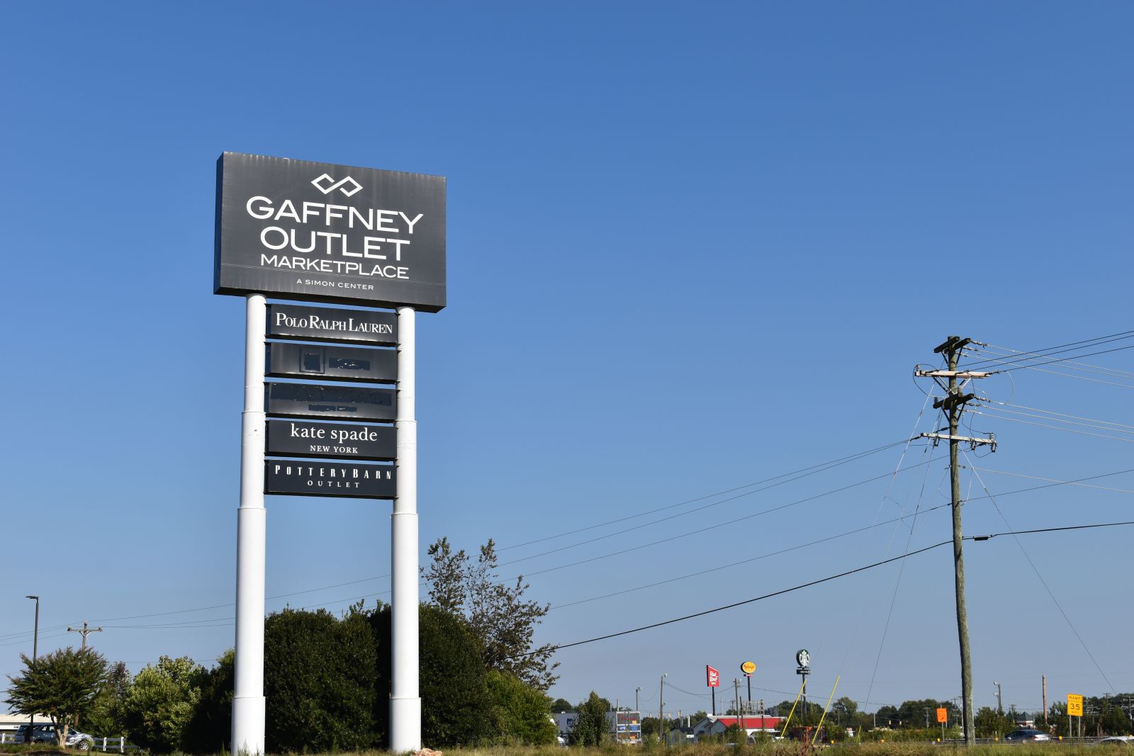As more national retailers move towards bankruptcy or an online-only platform, almost half the names have been crossed out on the Gaffney Outlet Marketplace sign off I-85. (Photo/Molly Hulsey)