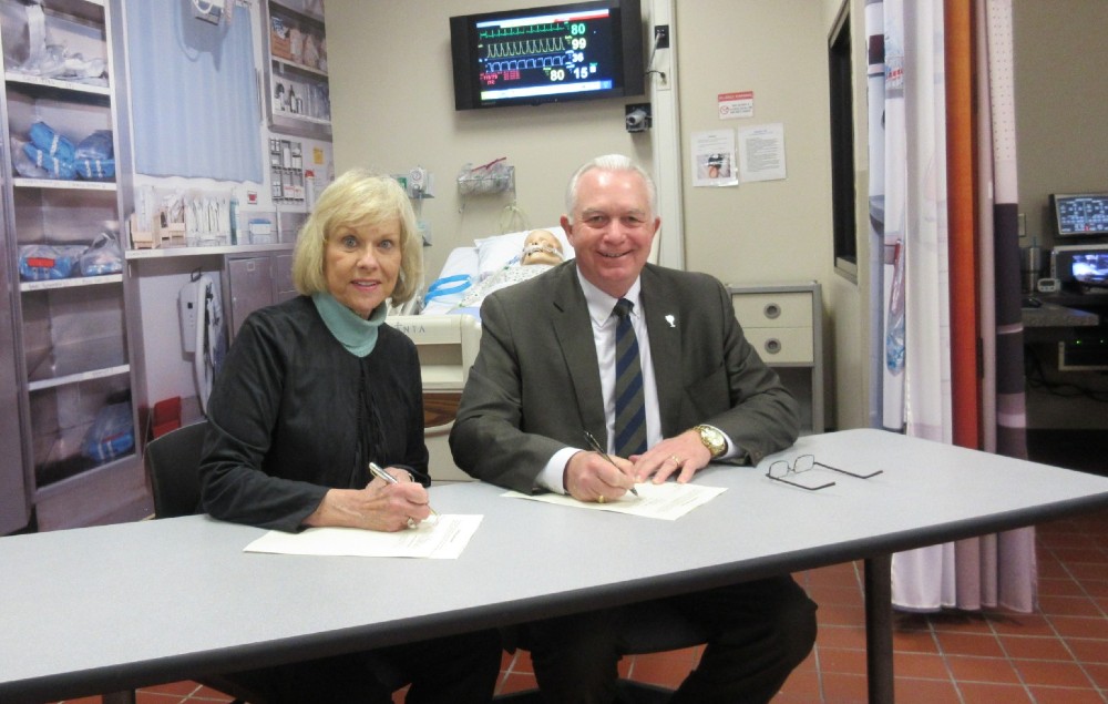 Barbara Lassiter, a former vice president at Greenville Technical College, and Keith Miller, president, sign a gift agreement in what will be known as the Dr. Barbara P. Lassiter Simulation Technologies and Training Center. 