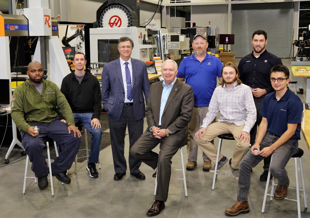 Students in Greenville Technical College??s bachelor??s in advanced manufacturing program include (from left) Christopher Scott, Shawn Hill, David Thacker, William Baker, Jonathan Devall and Vladislav Bondarchuk with (third from left) academic program director Philip M. Caruso and (fourth from left) Greenville Tech President Keith Miller at the Center for Manufacturing Innovation. (Photo/Provided)