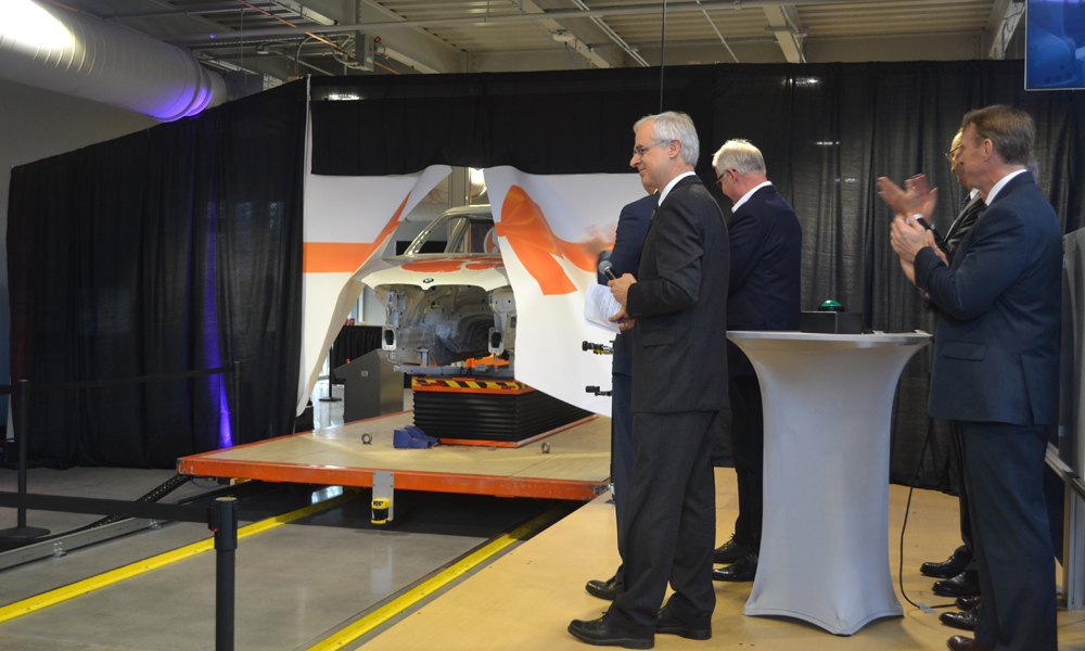 Officials representing Clemson University, Greenville Technical College, BMW Manufacturing and Siemens officially open the Vehicle Assembly Center by ??crashing? a ribbon with a vehicle moving along a prototype assembly line. (Photo/Ross Norton)