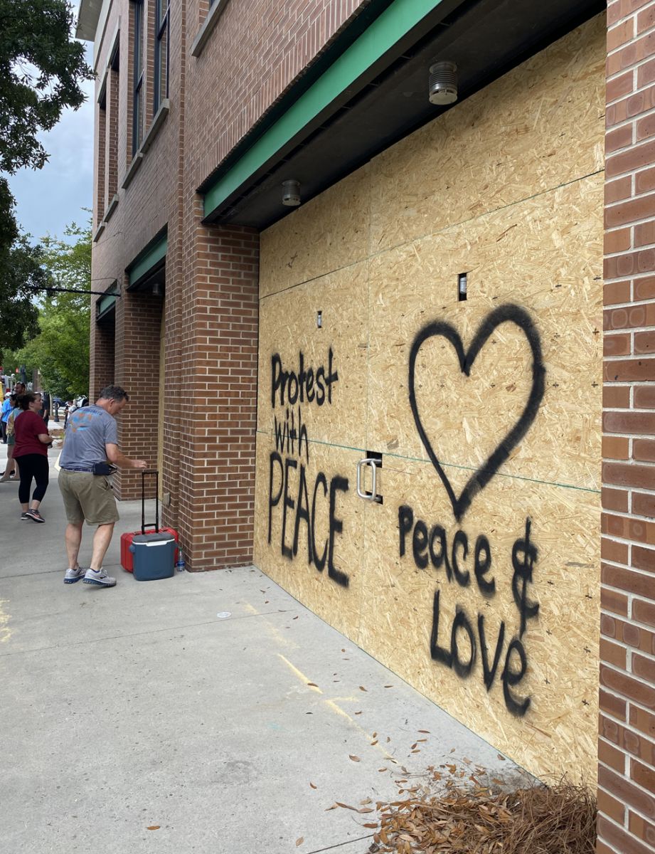 Volunteers helped board up windows on buildings and businesses on Richardson Avenue in Summerville on Sunday afternoon. (Photo/Andy Owens)