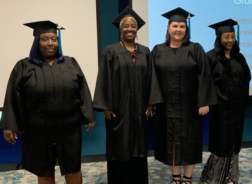 Deneka Doctor (left to right), Kindra Tucker, Andrea Walters and Diamond Wilson received diplomas Sunday through the Richland Library Career Online High School program. (Photo: Richland Library)