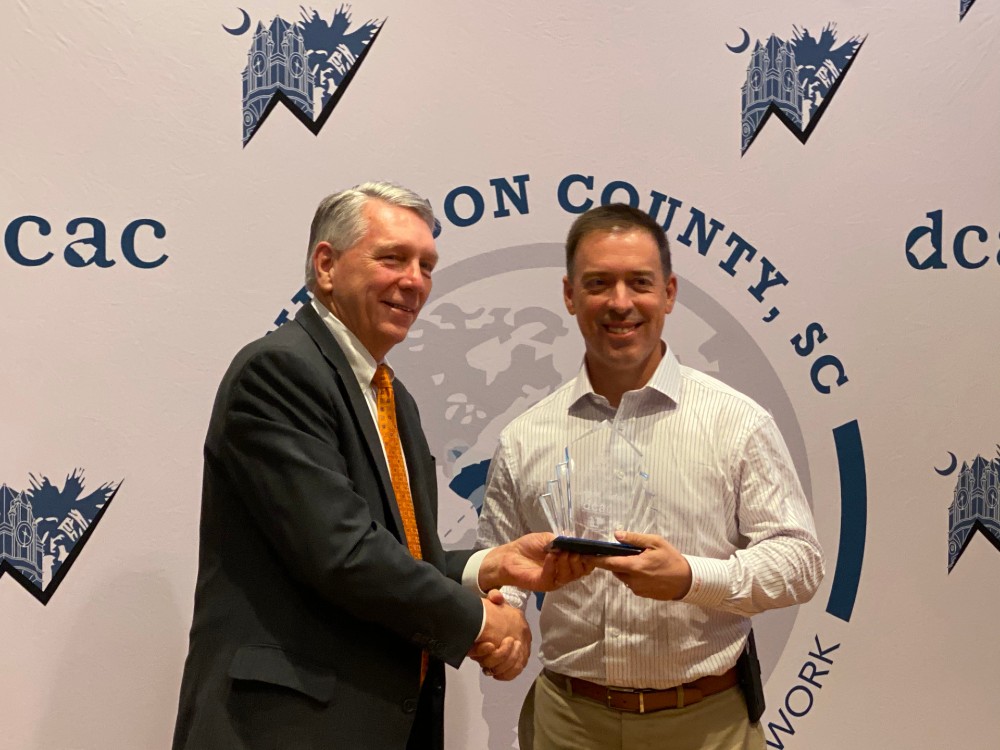Tim Sargent, president and CEO of Sargent Metal, receives an Employer Impact Award from Burriss Nelson, president of the Development Corp. of Anderson County. (Photo/Teresa Cutlip)