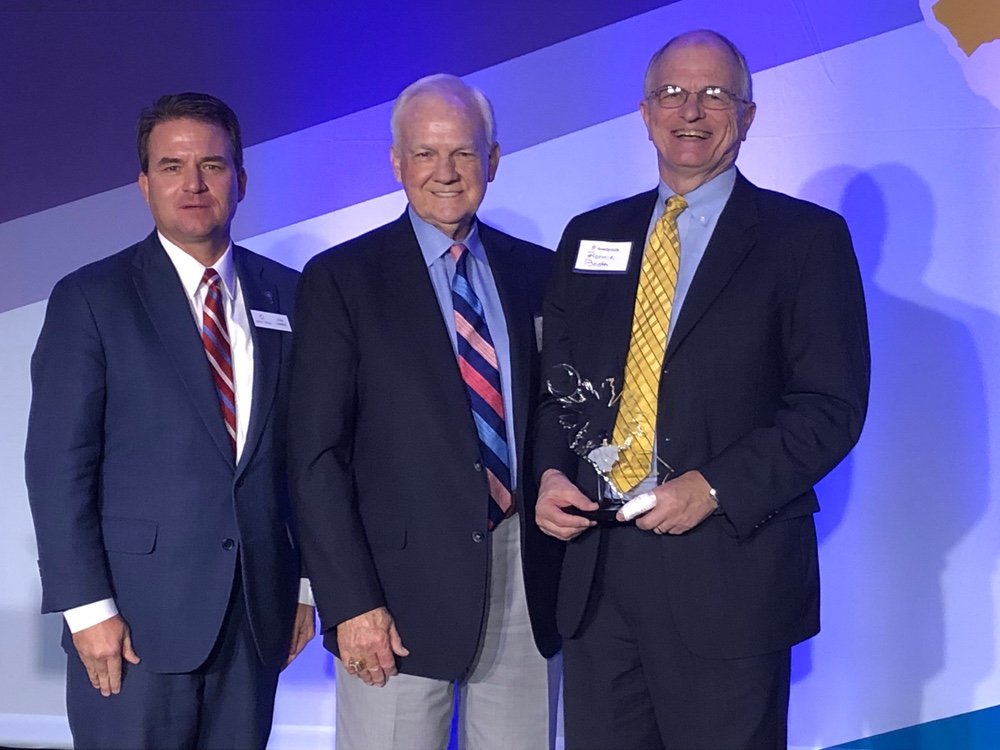 Ronnie Booth, former president of Tri-County Technical College, right, received the Spirit of the Upstate award Wednesday from John Lummus, president and CEO of Upstate SC Alliance, left, and Charles Dalton, retired president of Blue Ridge Electric Cooperative, who received the award in 2017. (Photo/Rick Jenkins)