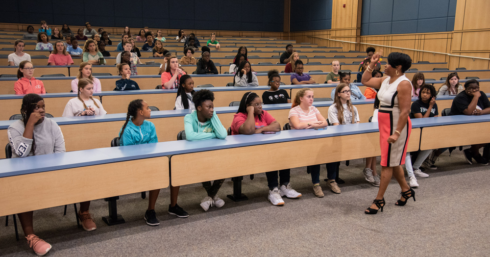 Students attending the Girls Day Out camp attend presentations from professionals. (Photo/Joe Bullinger for the Navy)
