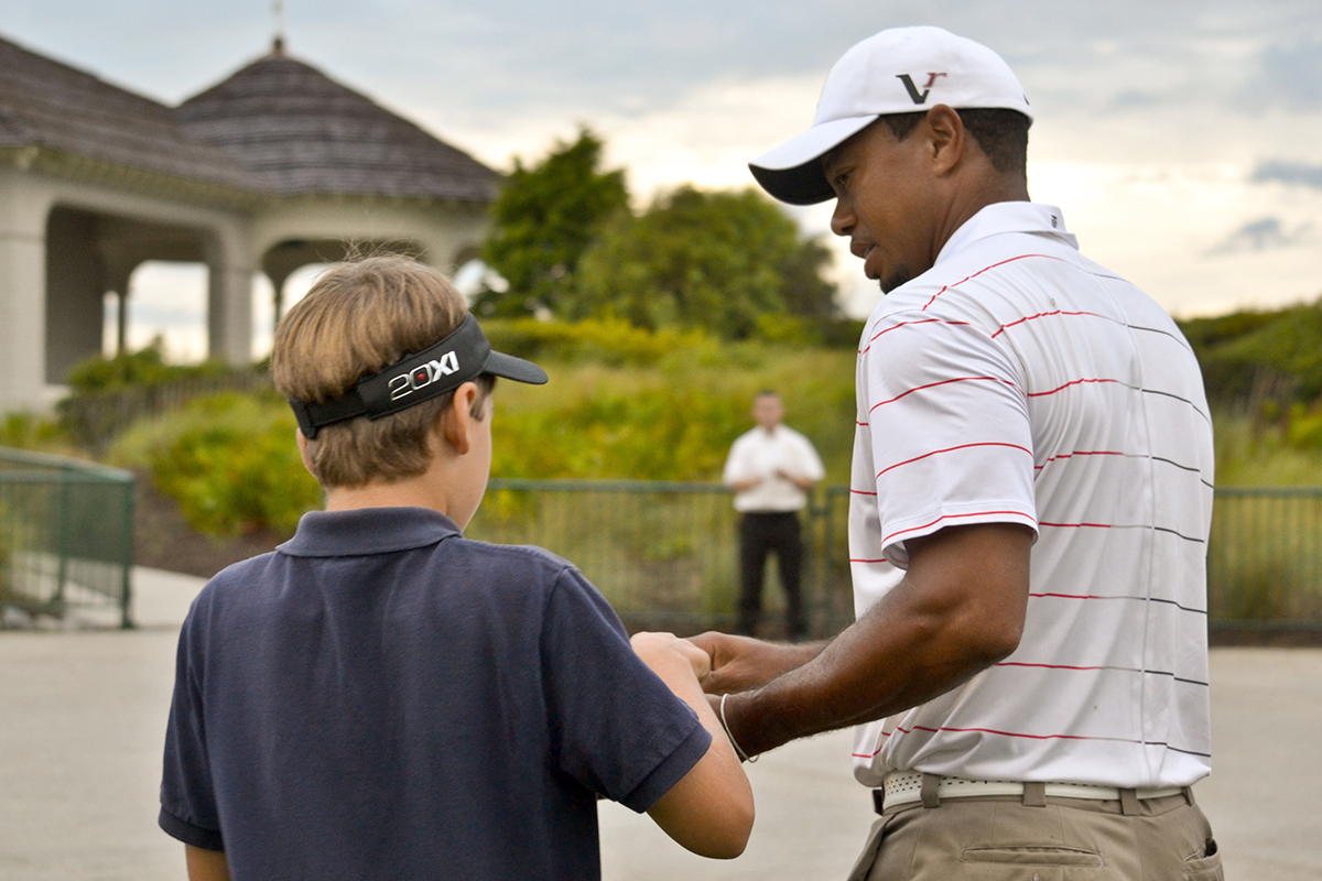 Tiger Woods gives a fan his autograph Aug. 8, 2012, before a practice round at the 2012 PGA Championship. (Photo/Leslie Burden, Charleston Regional Business Journal)