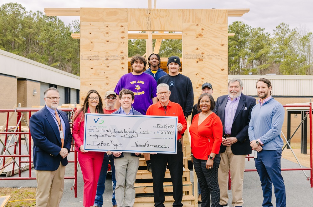 Members of the VisionGreenwood board of directors visited the tiny house project for a tour and to present a check supporting the workforce development project. (Photo/Provided)
