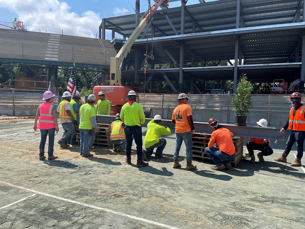 Construction workers and project managers from Choate Construction sign the beam before it‰ŰŞs lifted into place, a tradition in large-scale construction projects. (Photo/Provided)