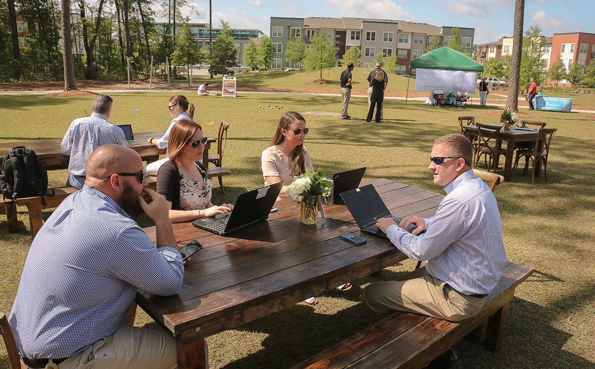 Workers meet outside to work at Nexton, a master-planned community in Summerville. The developer of the project has been acquired by Brookfield Residential. (Photo/Provided)