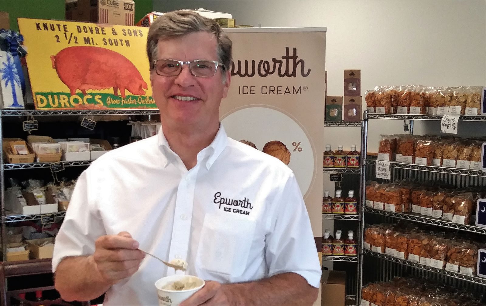 Dave Mackey, president of Epworth Ice Cream Co., takes a bite of peanut butter ice cream at Crave Market. (Photo/Travis Boland)