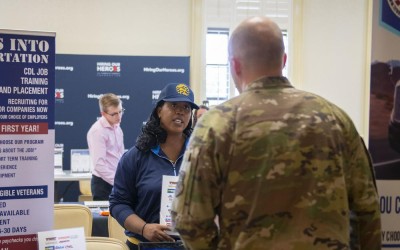 A U.S. Air Force Airman speaks to a business representative during the Hiring our Heroes Career Summit at Joint Base Charleston. (Photo/Senior Airman Sara Jenkins, U.S. Air Force)