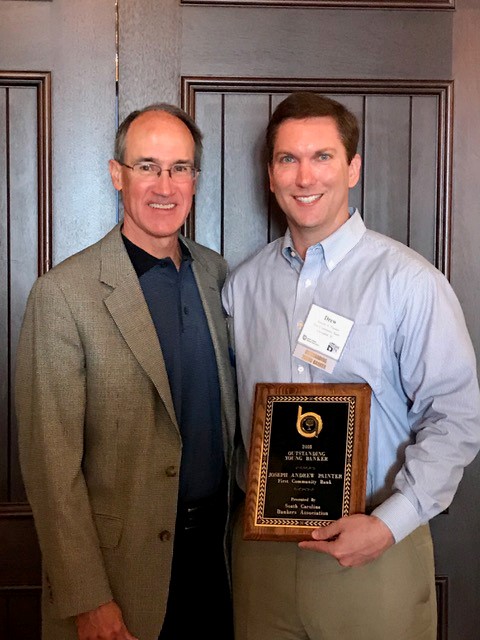 First Community Bank Columbia regional market president Drew Painter (right) was named the S.C. Banker's Association 2018 Outstanding Young Banker. Painter is joined by First Community Bank CEO Mike Crapps.