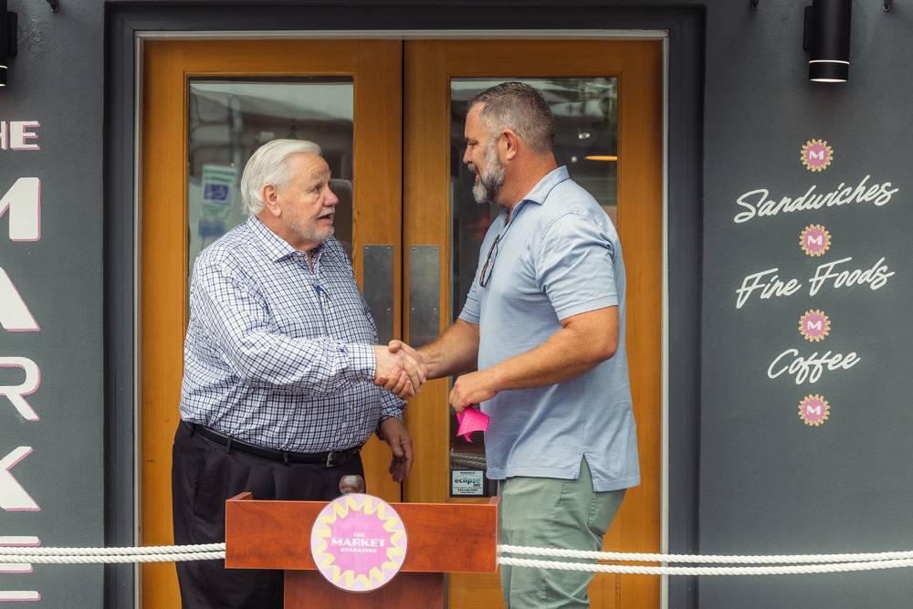 North Charleston Mayor Keith Summey congratulates Success Street Hospitality owner Boris Van Dyck on the opening of The Market at Paradiso. (Photo/Provided)