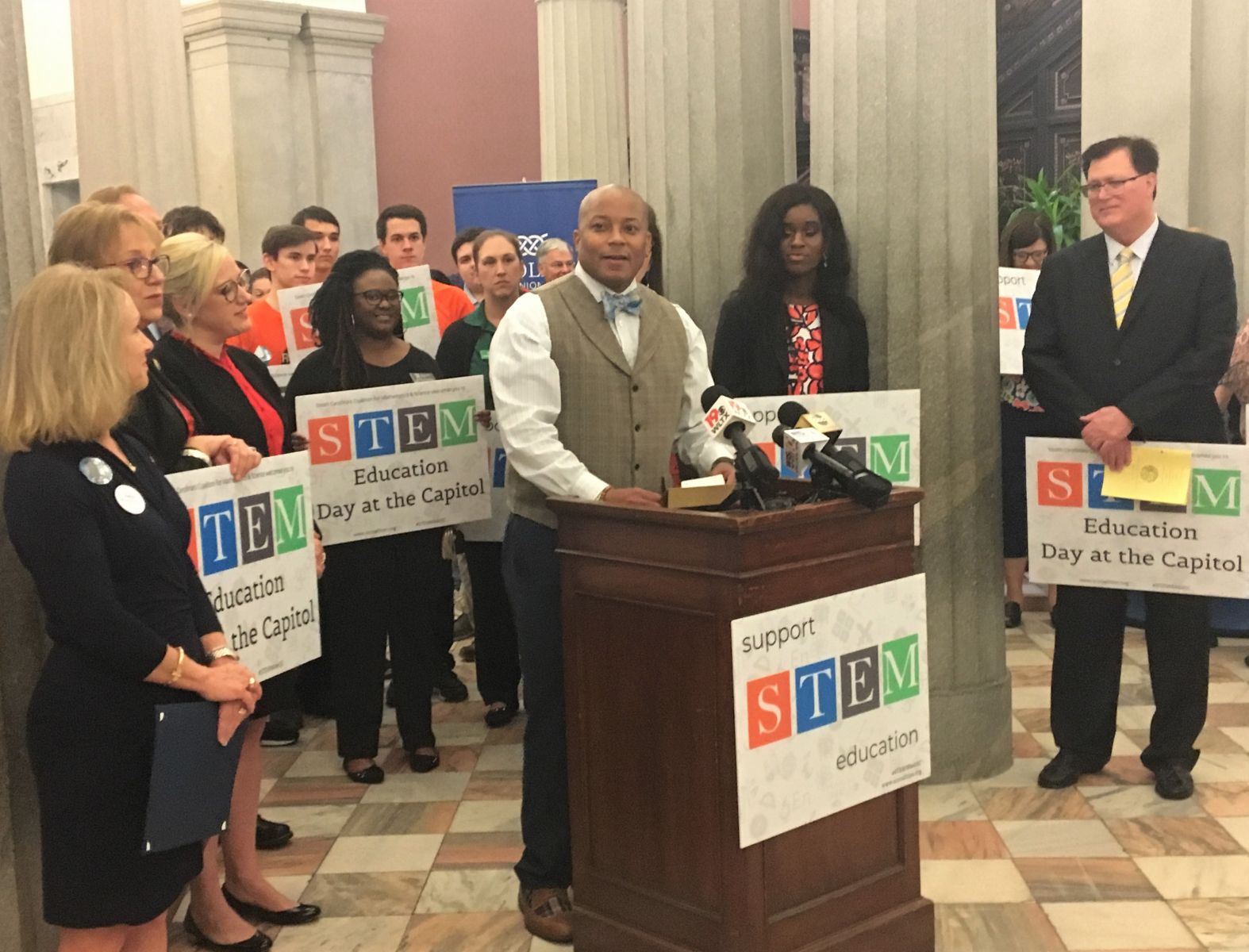 Kelly Mill Middle School science teacher Warren Wise (at podium) accepts the inaugural STEM Educator of the Year award on Tuesday at the S.C. Statehouse as Rep. Sylleste Davis (far left) and S.C. Speaker of the House Jay Lucas (far right) look on. (Photo/Melinda Waldrop)